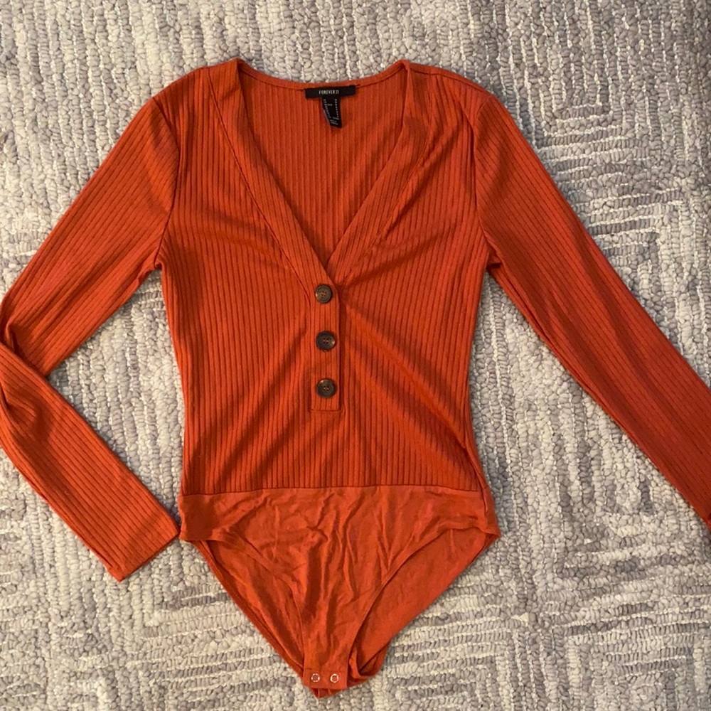 Orange knitted body suit with buttons